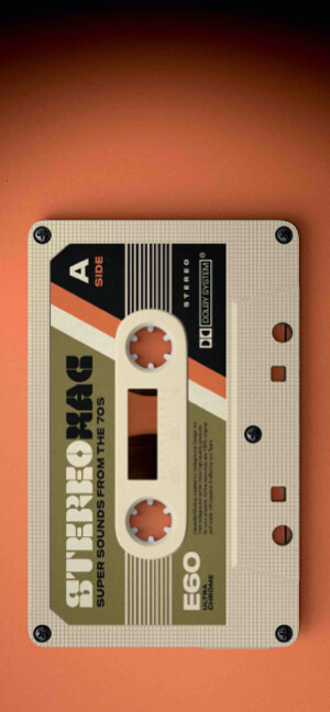 A top-down professional shot of a vintage beige and green cassette tape titled 'Stereo Max' resting on a vibrant orange background.