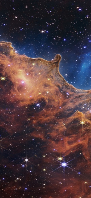 The Cosmic Cliffs of the Carina Nebula showing golden-orange dust clouds against a star-filled deep blue space.