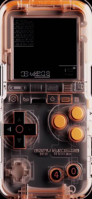 A close-up of a transparent orange handheld gaming console showing internal circuit boards and buttons on a dark background.
