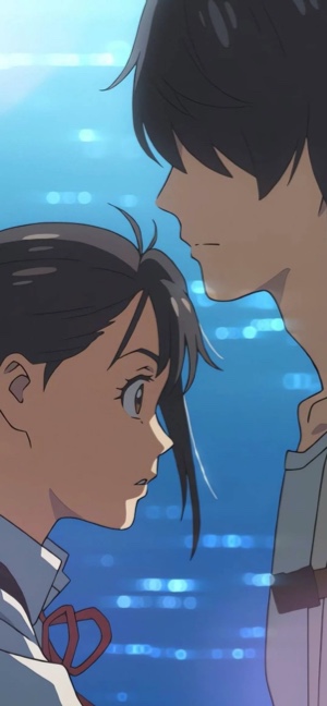 Anime characters Suzume Iwato and Souta Munakata looking at each other against a sparkling blue water background.