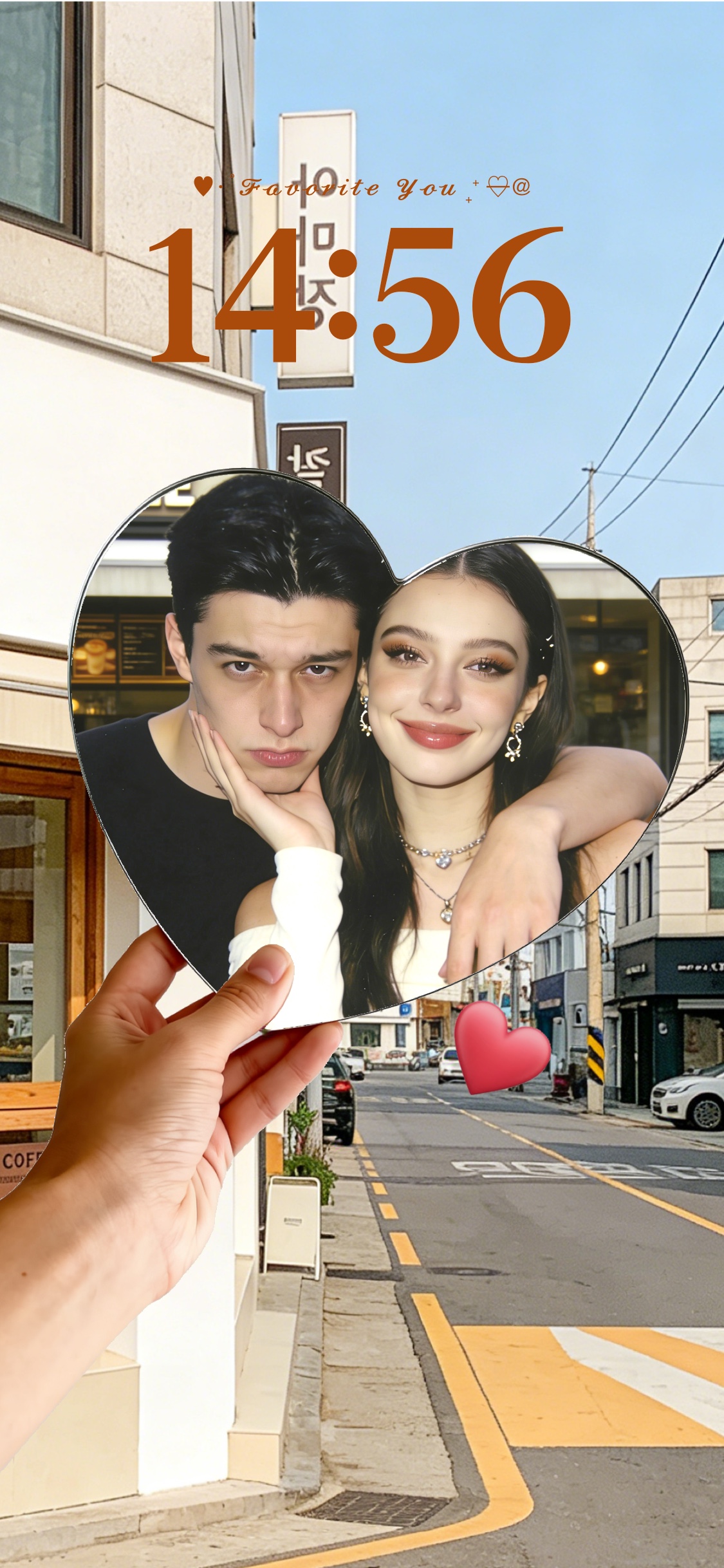 A hand holding a heart-shaped photo frame with a couple inside, over a sunny city street background, customizable static wallpaper template.