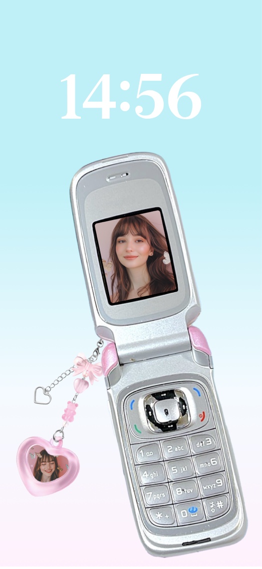 Silver Y2K flip phone with customizable photo screen and pink heart charm on a blue gradient background.